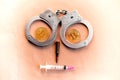 Bitcoins, a syringe, a bullet and handcuffs as a symbol of crime